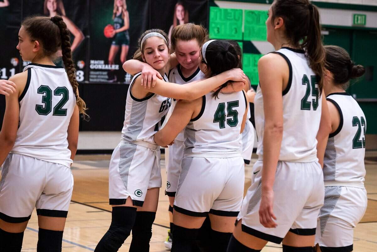 Granite Bay Grizzlies’ Sydney Howes (40), center, is embraced by Ali Tanfani (11), left, and Jenna Herrenschmidt (45) after the buzzer cementing their 57-50 loss to Rodriguez at the high school girls basketball Sac-Joaquin Section playoff game Thursday, Feb. 17, 2022, at Granite Bay High School.