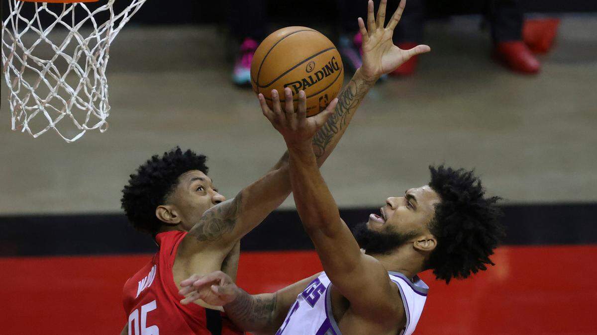 Sacramento Kings’ Marvin Bagley III, right, shoots, against Houston Rockets’ Christian Wood (35) during the second quarter of an NBA basketball game Saturday, Jan. 2, 2021, in Houston. (Carmen Mandato/Pool Photo via AP)