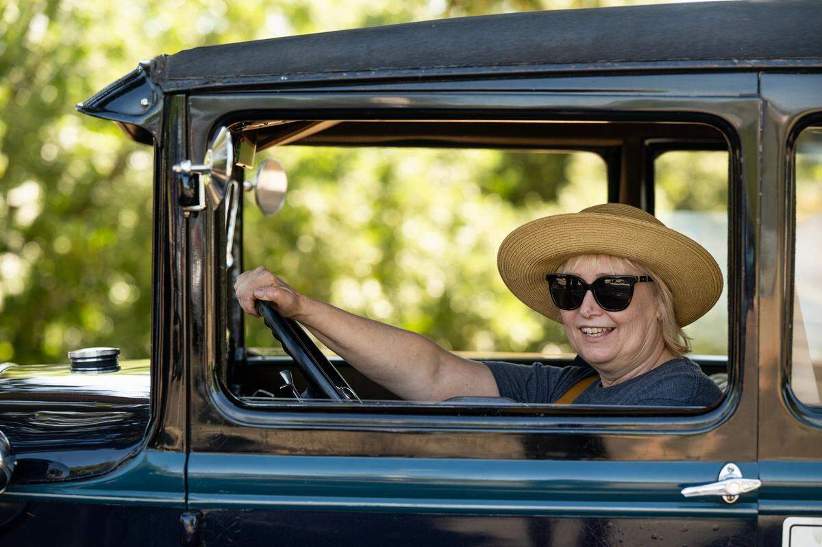Ivana Arostegui, sits behind the wheel of a 1928 Model A on Saturday in Sacramento after taking a driving lesson in the car. Appointments to schedule a lesson with a docents can be done on the California Automobile Museum website.