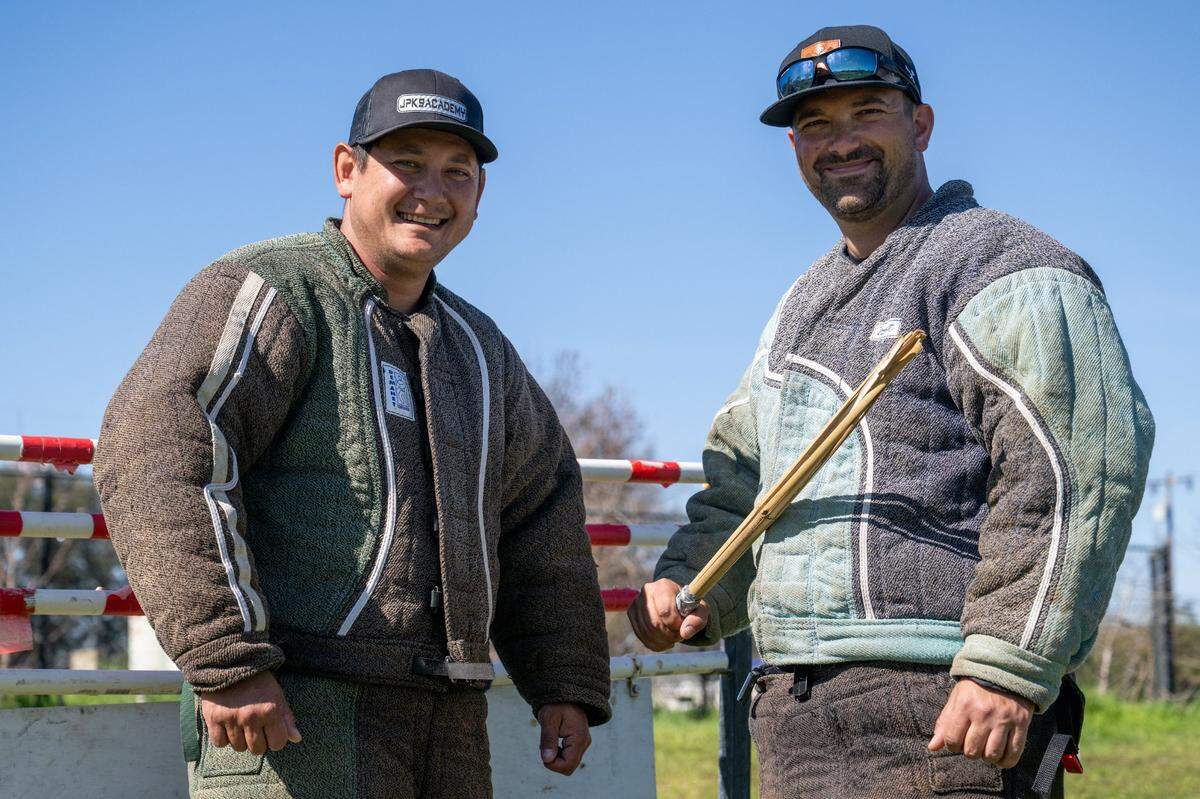 Juan Portillo and Spencer Bowman wear protective suits as they prepare to train their dogs in French ring  in Roseville in February.