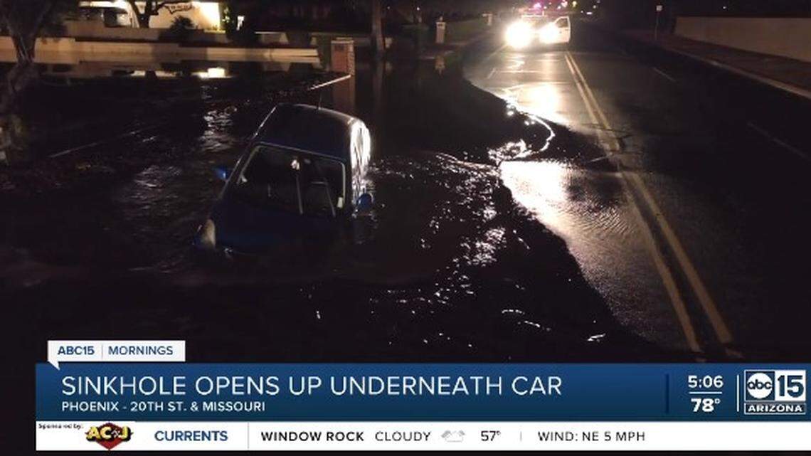 A woman driving on a Phoenix, Arizona, street hit a sinkhole possibly caused by a water main break. Neighbors rescued her from the hole.