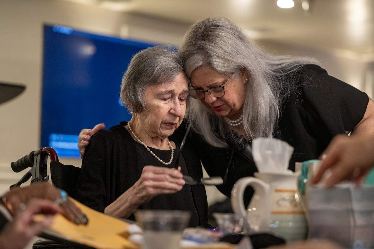 Liz Brown embraces her sister-in-law Berta Cable, after an emotional reading of a remembrance of her late husband, TV anchor Dick Cable, at The Invitation Room in Old Sacramento on Saturday. Dick Cable died in February.