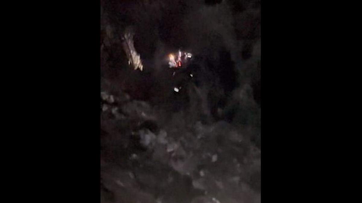 A helicopter hoists a rescuer and an injured driver to safety after a vehicle fell from a 400-foot cliff at Mount Wilson in California.
