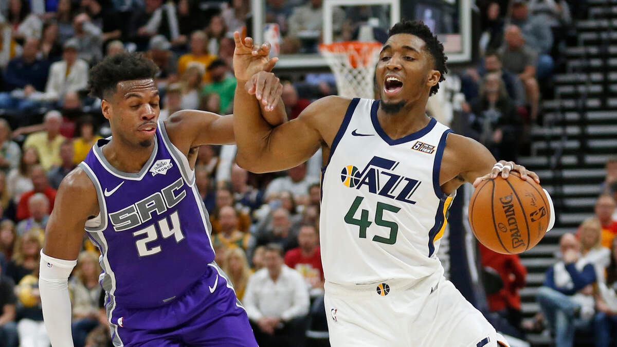 Utah Jazz guard Donovan Mitchell (45) drives around Sacramento Kings guard Buddy Hield (24) during the second half of an NBA basketball game Friday, April 5, 2019, in Salt Lake City. (AP Photo/Rick Bowmer)