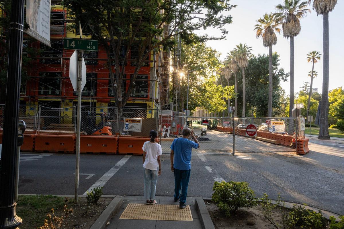 Pedestrians walk around the crosswalk closure at 14th and N streets in June, instead of taking the detour to cross a block away.