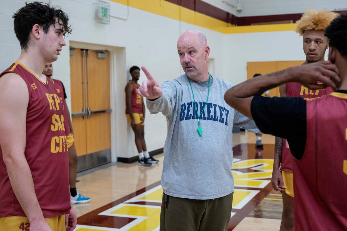 Coach Andrew Jones, center, explains where guard Leo Wagner should be during the play during the men’s basketball practice on Wednesday at Sacramento City College.