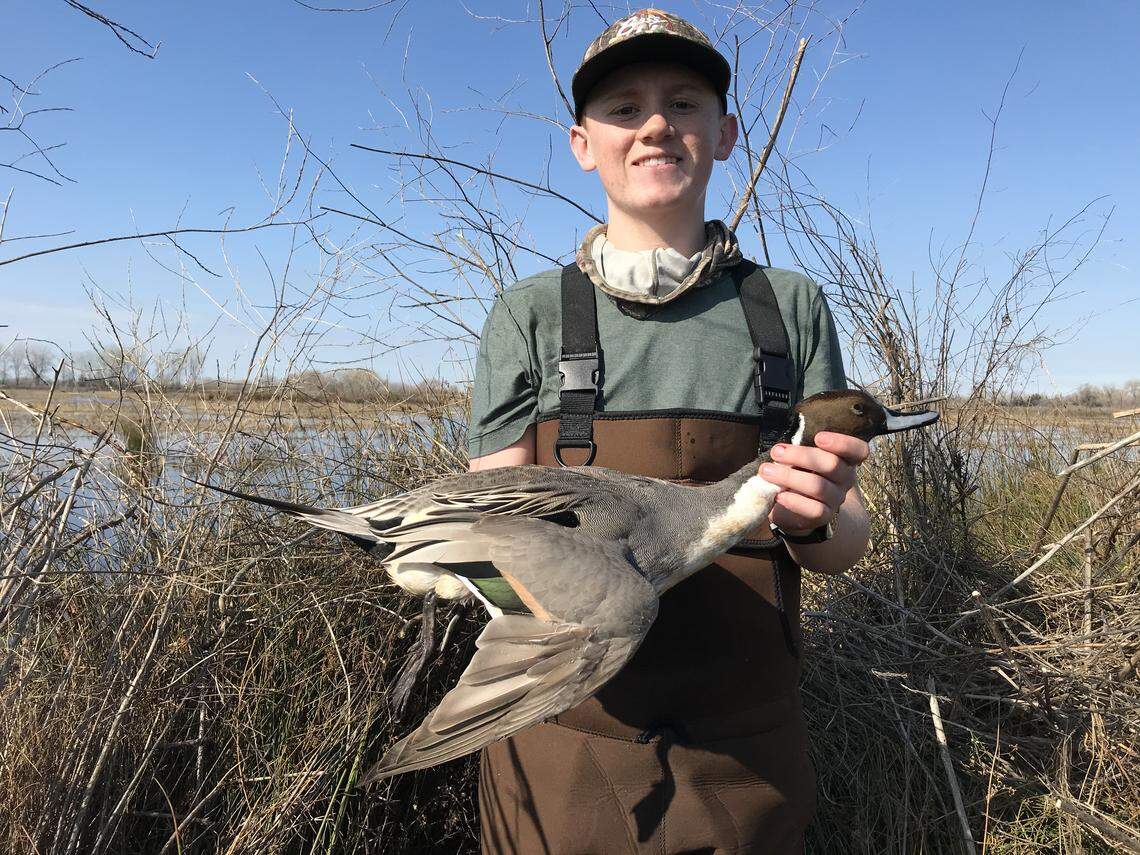 Tanner Martinez, 14, holds a pintail duck he shot on Feb. 8, 2020 at the Gray Lodge Wildlife Area in Gridley.