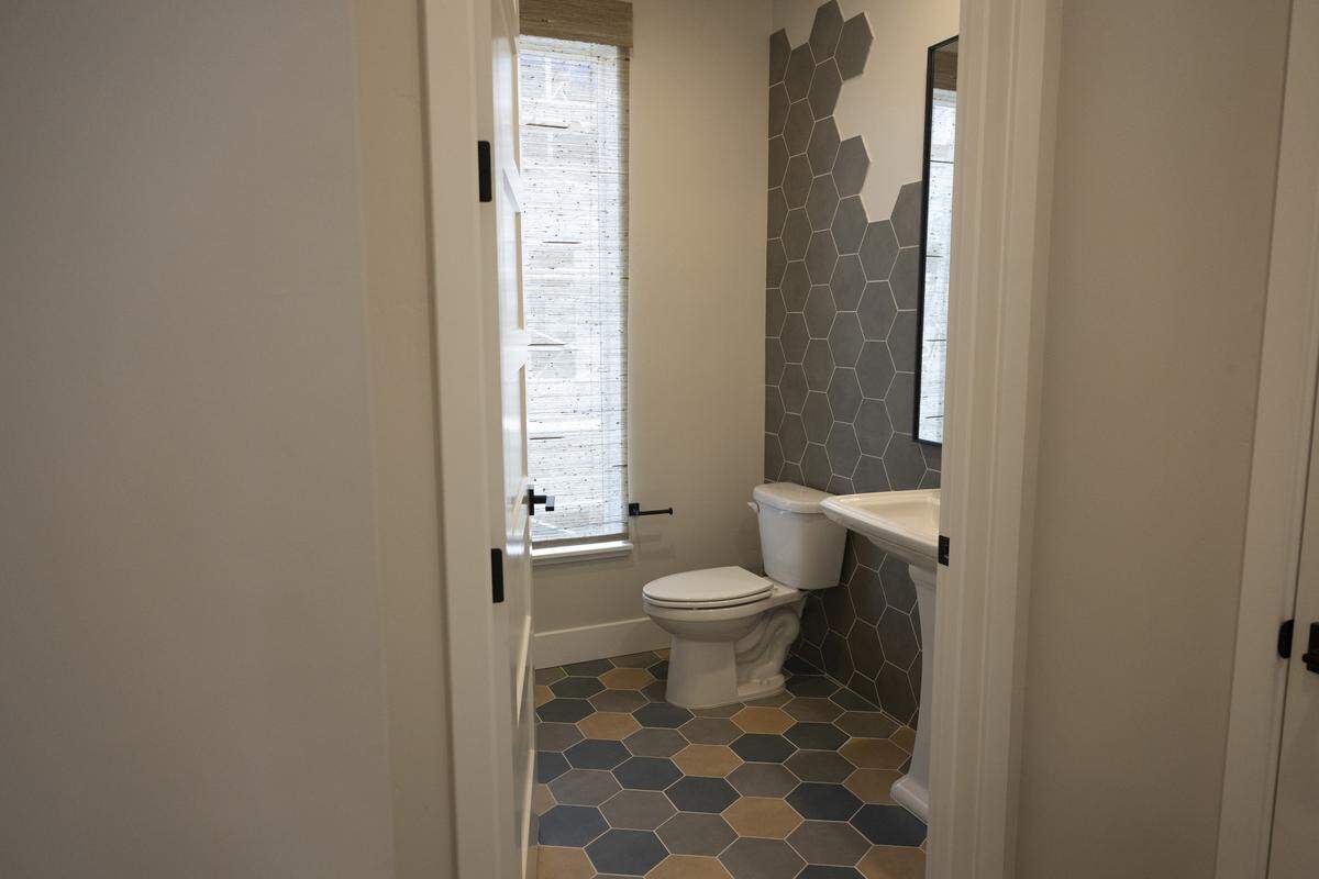 A bathroom inside one of the display units at the R21 housing development in Sacramento on Thursday. The unit uses hexagonal tiles as a part of drawing inspiration from The Sacramento Bee, the parking lot of which the housing development is built on.