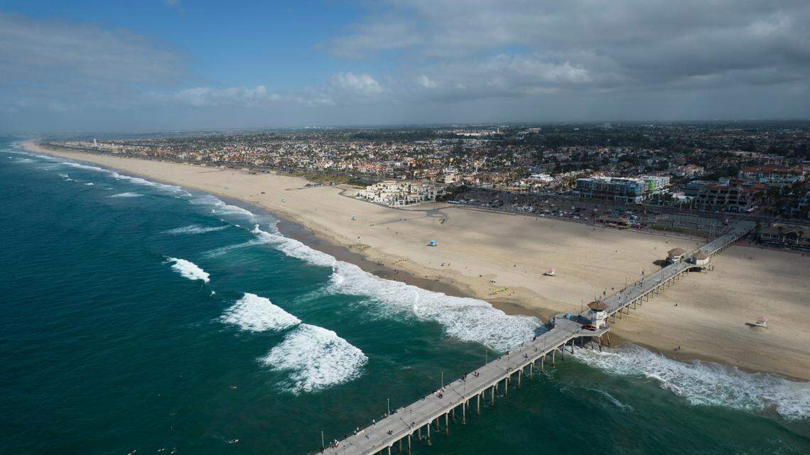 This aerial photo shows the pier and shoreline in Huntington Beach, Calif., on Oct. 11, 2021. A coyote attacked and injured a girl on Southern California’s Huntington Beach.
