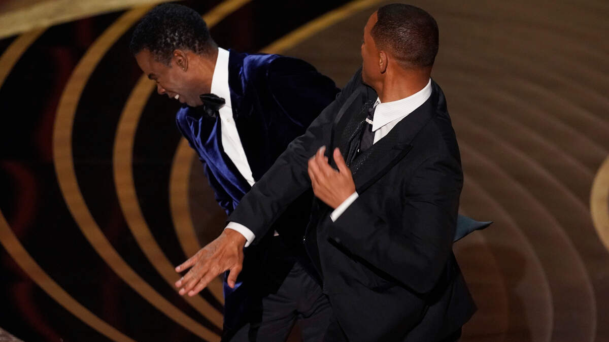 Will Smith, right, hitting Chris Rock at the Oscars on Sunday in Los Angeles.