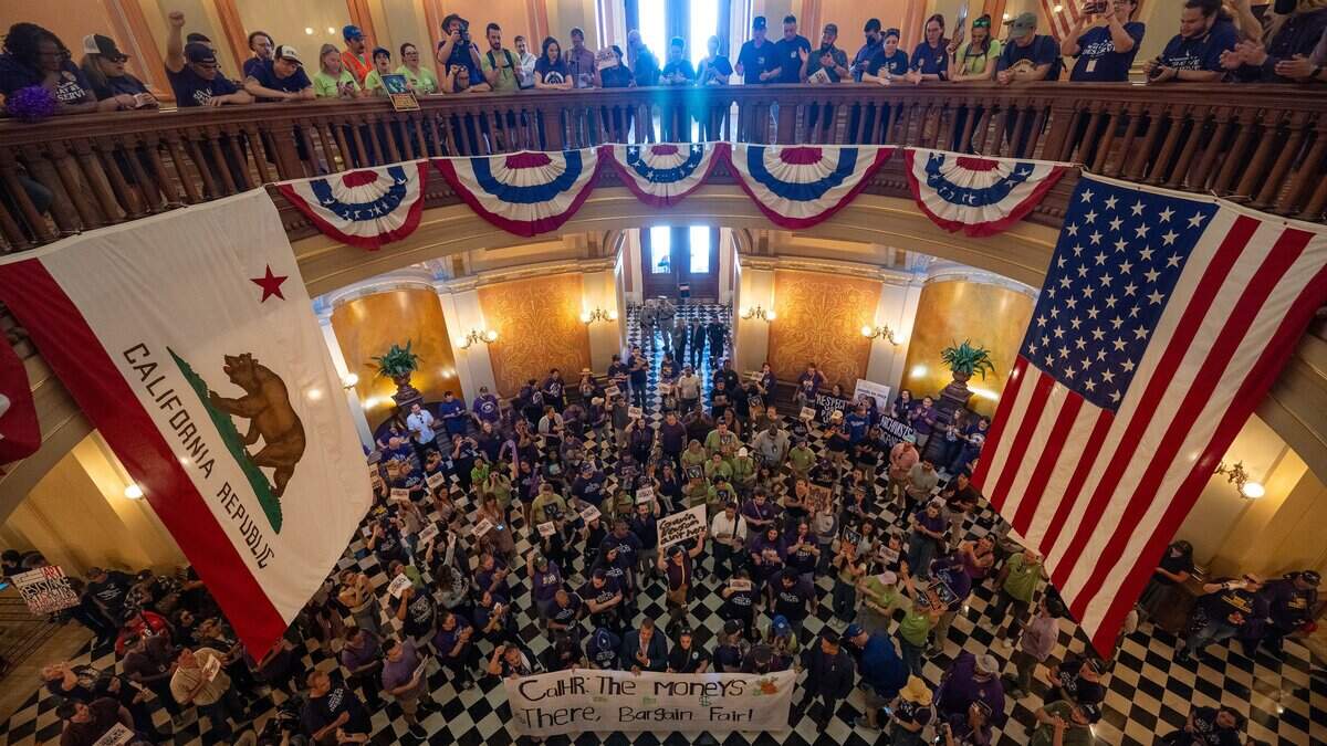 State workers fill the California Capitol rotunda in Sacramento after moving their protest inside during a rally organized by SEIU Local 1000 against Gov. Gavin Newsom's return-to-office policy on Wednesday, July 1, 2026.