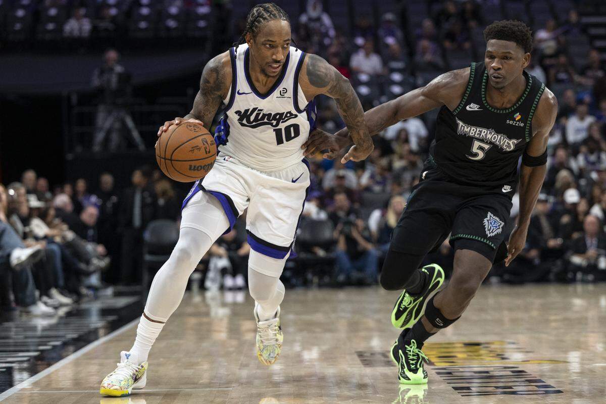 Sacramento Kings forward DeMar DeRozan (10) runs the ball by Minnesota Timberwolves guard Anthony Edwards (5) during a game at Golden 1 Center in Sacramento on Sunday, Nov. 9, 2025.