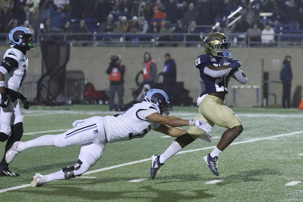 Rhode Island Rams defensive back Andre Depina-Gray (30) attempts to stop UC Davis Aggies running back Jordan Fisher (20) as he runs a 50-yard touchdown in the third quarter of a second-round NCAA Division FCS playoff game at UC Davis Health Stadium on Saturday.