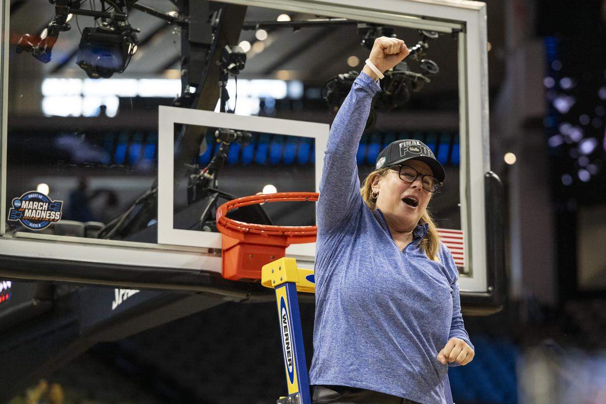 UCLA head coach Cori Close reacts after cutting down the net after winning the Sacramento Regional 2 as a part of the March Madness tournament at Golden 1 Center in Sacramento on Sunday, March 29, 2026.