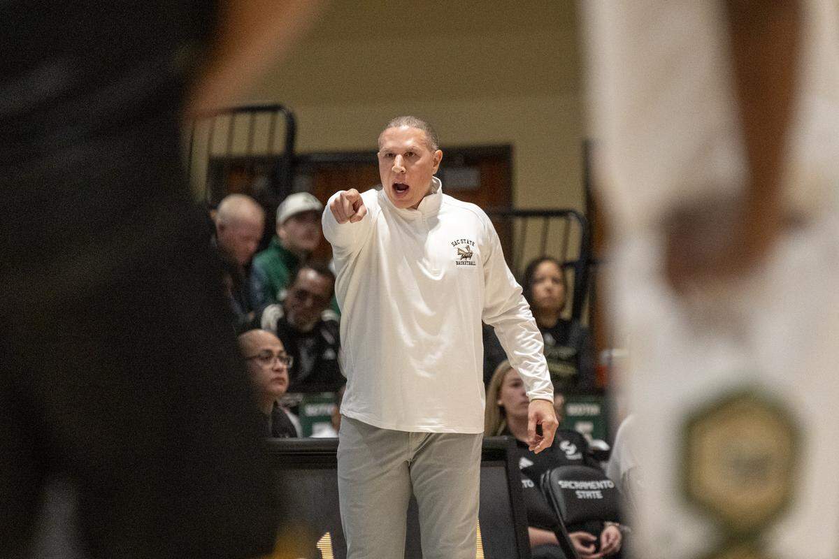 Sacramento State Hornets men's basketball coach Mike Bibby talks to players during the season-opening game at the Hornet Pavilion on Tuesday in Sacramento.