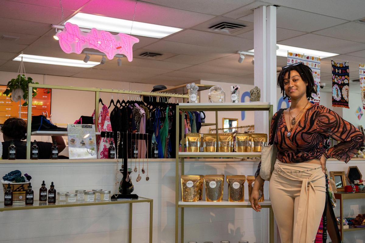 Sacred Products owner Dana Willis stands with her merchandise on Aug. 3 at CLTRE Club, a Sacramento venue that helps new business owners establish a brick-and-mortar location.