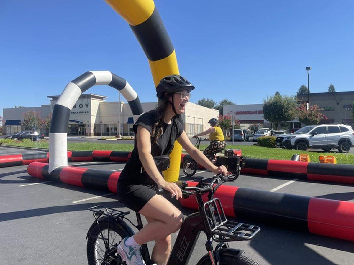 Nicole Porter of Sacramento Area Council of Governments test rides an e-bike during Elk Grove’s program launch Tuesday, Sept. 3, 2024.