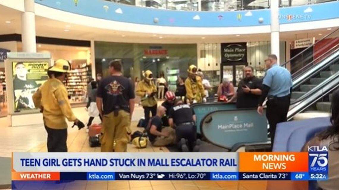 A teen girl had to be rescued after getting her hand stuck in an escalator railing at MainPlace Mall in Santa Ana, California firefighters say.