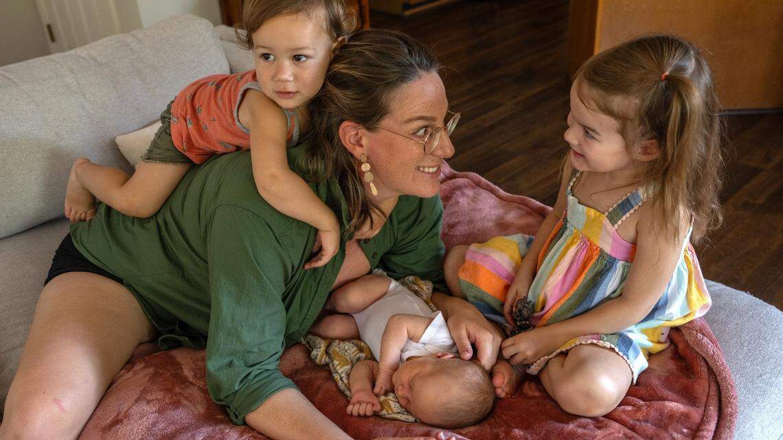 Katie Swedo, 35, whose first birth at age 19 was a C-section, has her hands full now with her three children, 10-day old Winona, Emrys, 1, and Seneca, 3, in Fair Oaks on Friday, Aug. 11, 2023. Her first child was given up for adoption but the others were all born VBAC. Seneca and Emrys were born at a birth center and Winona was a home birth. Swedo doesn’t recall her obstetrician ever mentioning the impact a non-emergency C-section would have on her future births.