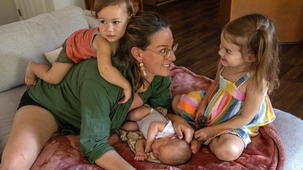 Katie Swedo, 35, whose first birth at age 19 was a C-section, has her hands full now with her three children, 10-day old Winona, Emrys, 1, and Seneca, 3, in Fair Oaks on Friday, Aug. 11, 2023. Her first child was given up for adoption but the others were all born VBAC. Seneca and Emrys were born at a birth center and Winona was a home birth. Swedo doesn’t recall her obstetrician ever mentioning the impact a non-emergency C-section would have on her future births.