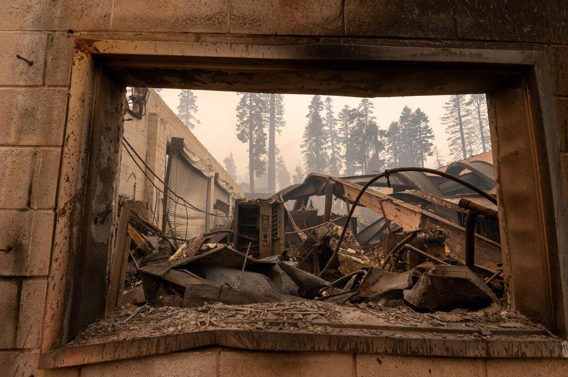 A maintenance building destroyed during the Caldor Fire at the Sierra-at-Tahoe ski resort smolders on Monday, Aug. 30, 2021. The resort used snow blowers spraying water to save many of its structures.