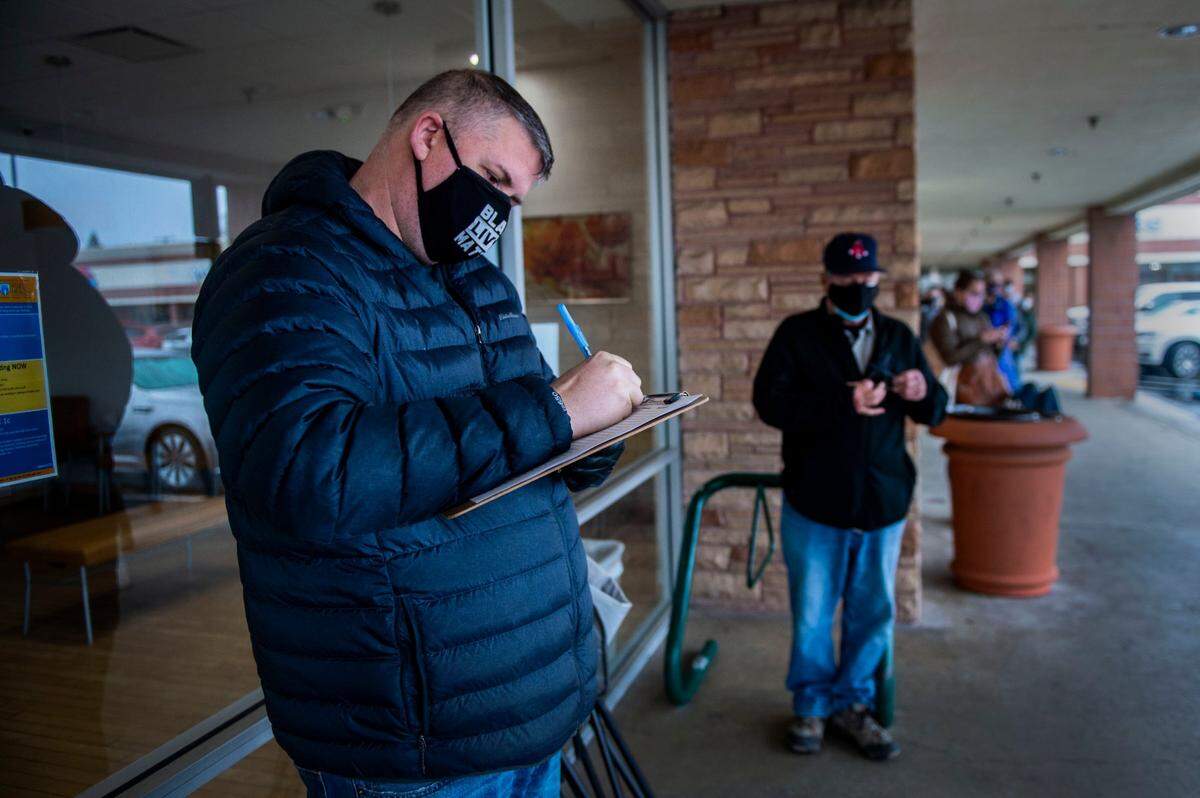 Carmichael resident Paul Andrews adds his name to a vaccine wait list after standing in line for two hours outside of Urgent Care Now in Arden-Arcade before they opened, Friday, Feb. 19, 2021. More than two dozen people showed up in the morning to add their names to the list hoping they’d get a call to get their COVID-19 vaccination if the clinic had any cancellations.