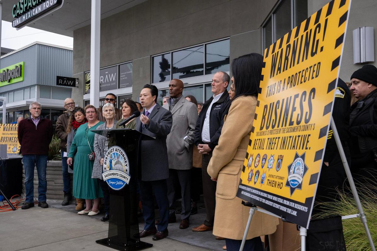Sacramento County District Attorney Thien Ho, joined by Sheriff Jim Cooper, Supervisor Rich Desmond and business owners, announces the immediate enforcement of Proposition 36, designed to combat retail theft, during a press conference at the Howe ‘Bout Arden Shopping Center in Arden Arcade on Tuesday, Dec. 17, 2024.