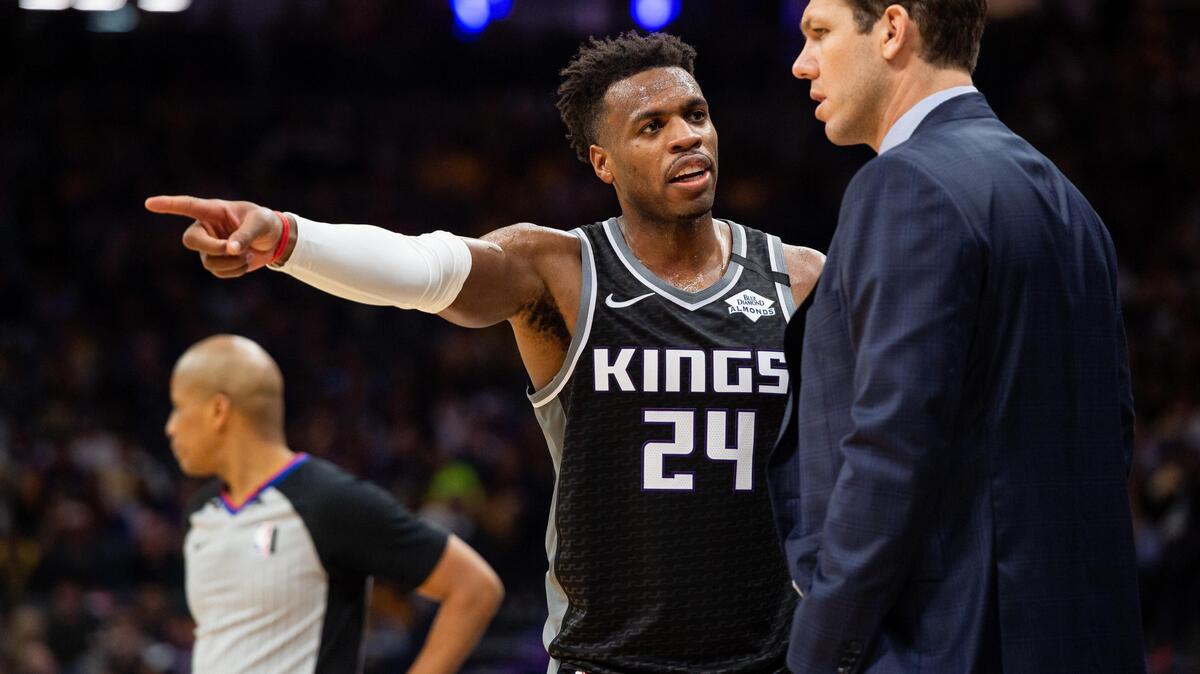 Sacramento Kings guard Buddy Hield (24) goes to the bench to talk with Sacramento Kings head coach Luke Walton in the fourth period at Golden 1 Center on Saturday, Feb. 1, 2020, in downtown Sacramento.