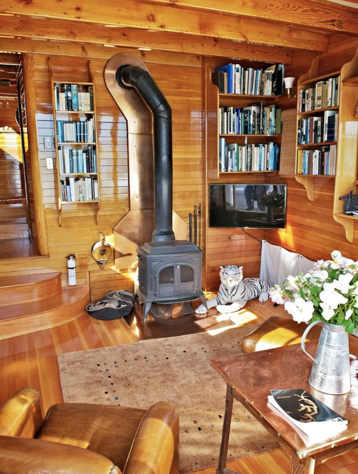 The salon and fireplace inside the Mirene, a houseboat for sale for $1.8 million.