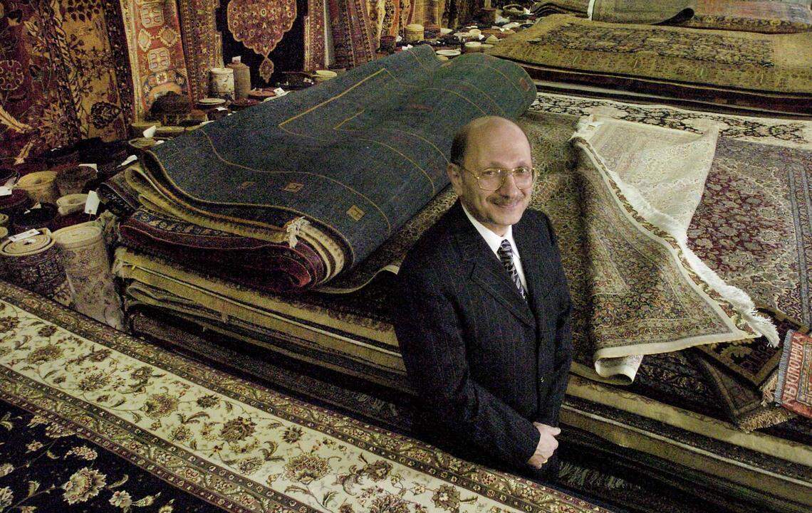 The late Mansour Yaghoubian stands amid his inventory at Mansour's Oriental Rug Gallery in 2004. His children plan to shut down the longtime Arden Arcade store. 