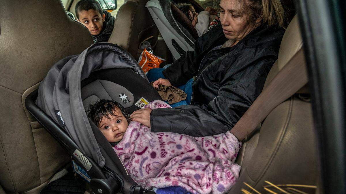 “My children are everything to me,” said homeless mother Geri Wells, 36, alongside children Orion Gonzales, 3 months, Gabriel Gonzales, 9, and Gracie Gonzales, 2, far right, in the SUV they are living in, Thursday, Dec. 9, 2021, in Rancho Cordova after the city towed their motorhome last month.