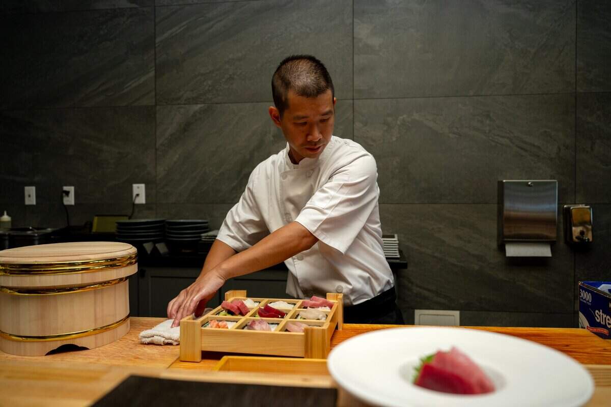 Frank Zhu, owner and chef at Chef Frank Japanese Cuisine, prepares a $60 mystery box at his sushi restaurant in North Natomas last month.