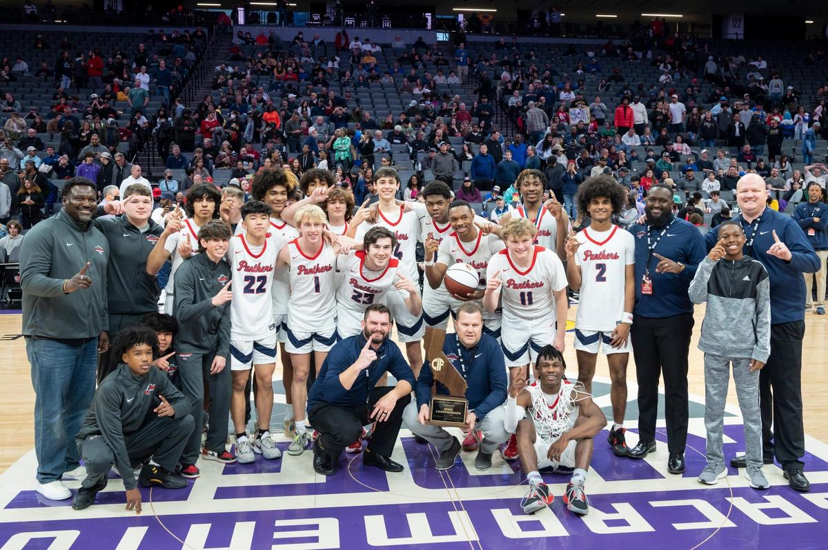 San Joaquin Memorial Panthers pose with the trophy after winning the CIF State Division II Boys Basketball Championship against the Pacifica Christian Tritons on Saturday, March 11, 2023, at Golden 1 Center in Sacramento. The Panthers defeated the Tritons 58-47.