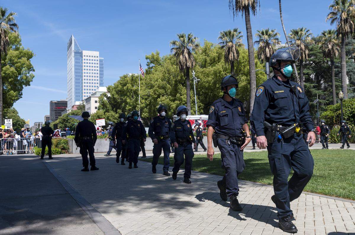 California Highway Patrol officers guard the state Capitol grounds during a protest on Thursday, May 7, 2020 in Sacramento during the coronavirus pandemic.