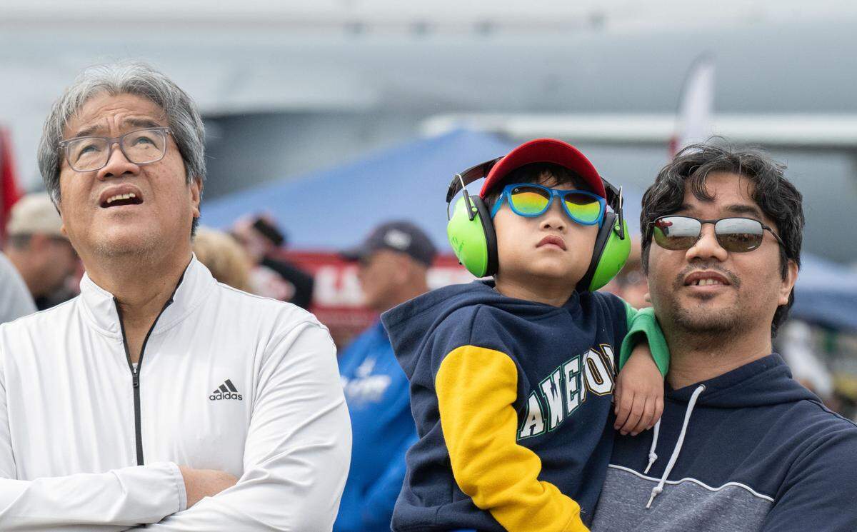 Emmanuel Santos, left, his grandson Ian and son Evan watch the U.S. Marine Corps F-35B demonstration at the California Capital Airshow at Mather Airport on Saturday, March 22, 2025.