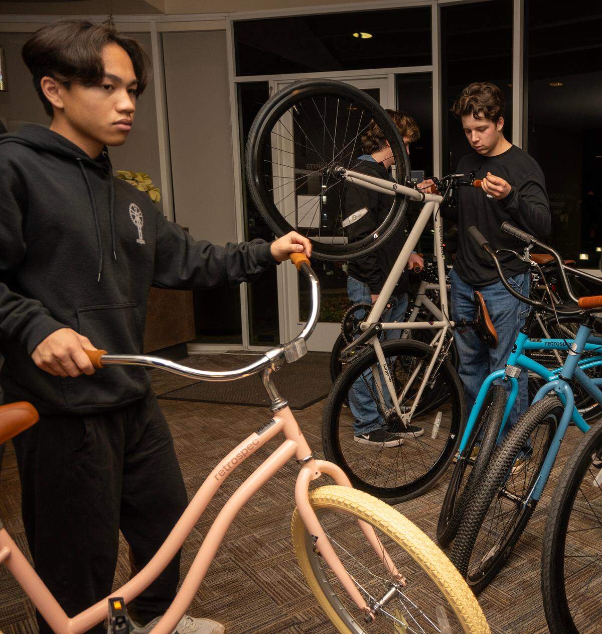 Riley Domine, 17, left, and Winston Holtkamp, 17, with Boys 4 Bikes, unload donated bikes Tuesday to be distributed to families at Stanford Youth Solutions.