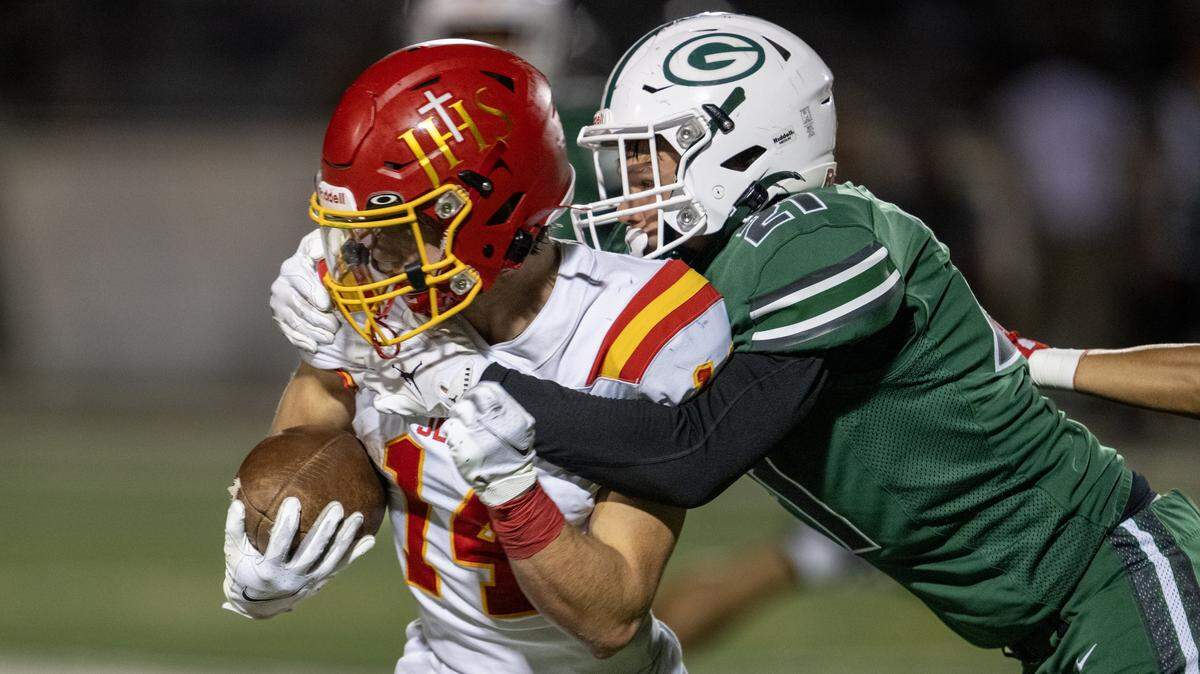 The Granite Bay Grizzlies' Ian Eckland tackles the Jesuit Marauders' Stevie Hughes (14) after a catch in September. The Marauders move to No. 2 in the rankings this week. 