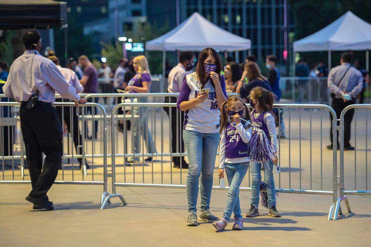 Chanel Durkee, of Sacramento, waits to enter the Sacramento King’s first preseason game with her daughters Clara, 7, and Evelyn, 5, at Golden 1 Center in downtown Sacramento on Oct. 4.