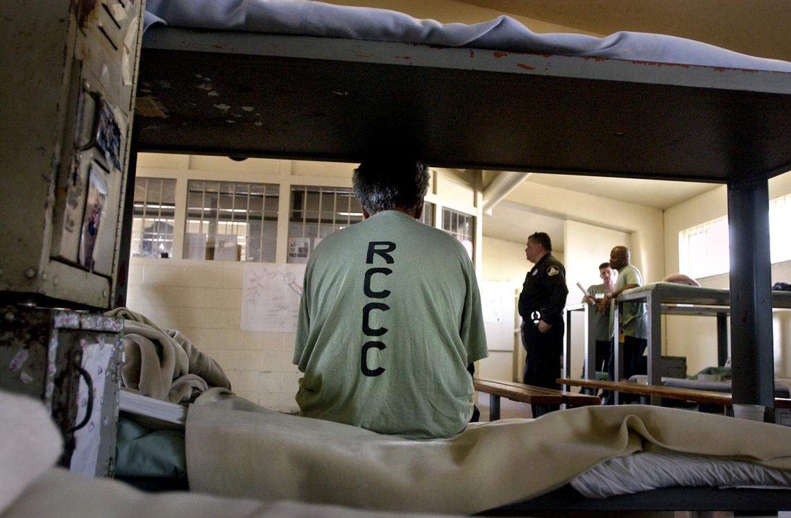 A man sits on his bed at Rio Cosumnes Correction Center in 2004.