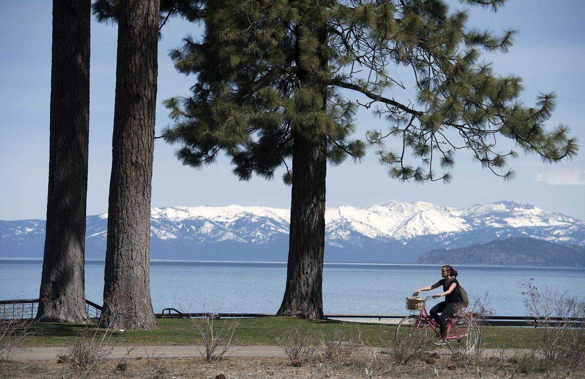 A cyclist rides along a bike trail near Highway 50 in South Lake Tahoe.