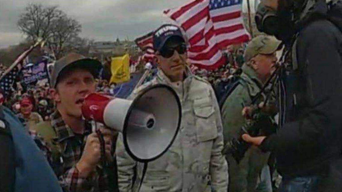 A federal response in opposition to a motion to dismiss charges against Sean Michael McHugh, 34, of Auburn — seen holding a megaphone in this video image provided by prosecutors — alleges that McHugh sprayed U.S. Capitol Police officers with a chemical substance and assaulted them with a metal sign during the Jan. 6, 2021, insurrection at the U.S. Capitol.
