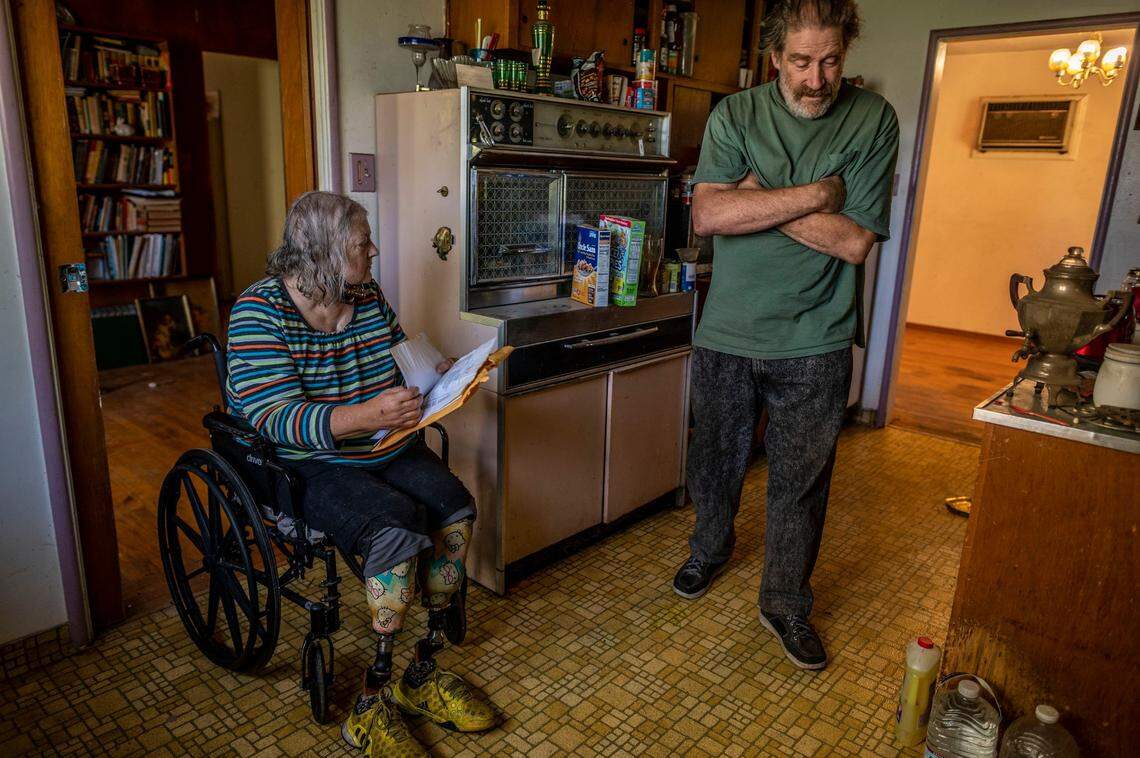 Linda Siegrist, 67, and her husband Bruce, 66, who have been married for 43 years, stand in their kitchen on Nov. 4, as they worry about keeping their home that was placed into receivership because of code violations. “They were going to take out all the kitchen cupboards and knock out a wall,” said Siegrist. “I thought, ‘there is nothing wrong with it.’”