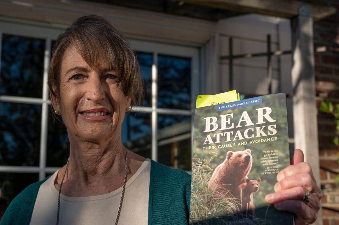 Laurel-Rose Von Hoffmann-Curzi holds a book on bear attacks at her Orinda home on Monday, less than a month after surviving a bear attack in her Tahoe Vista cabin.