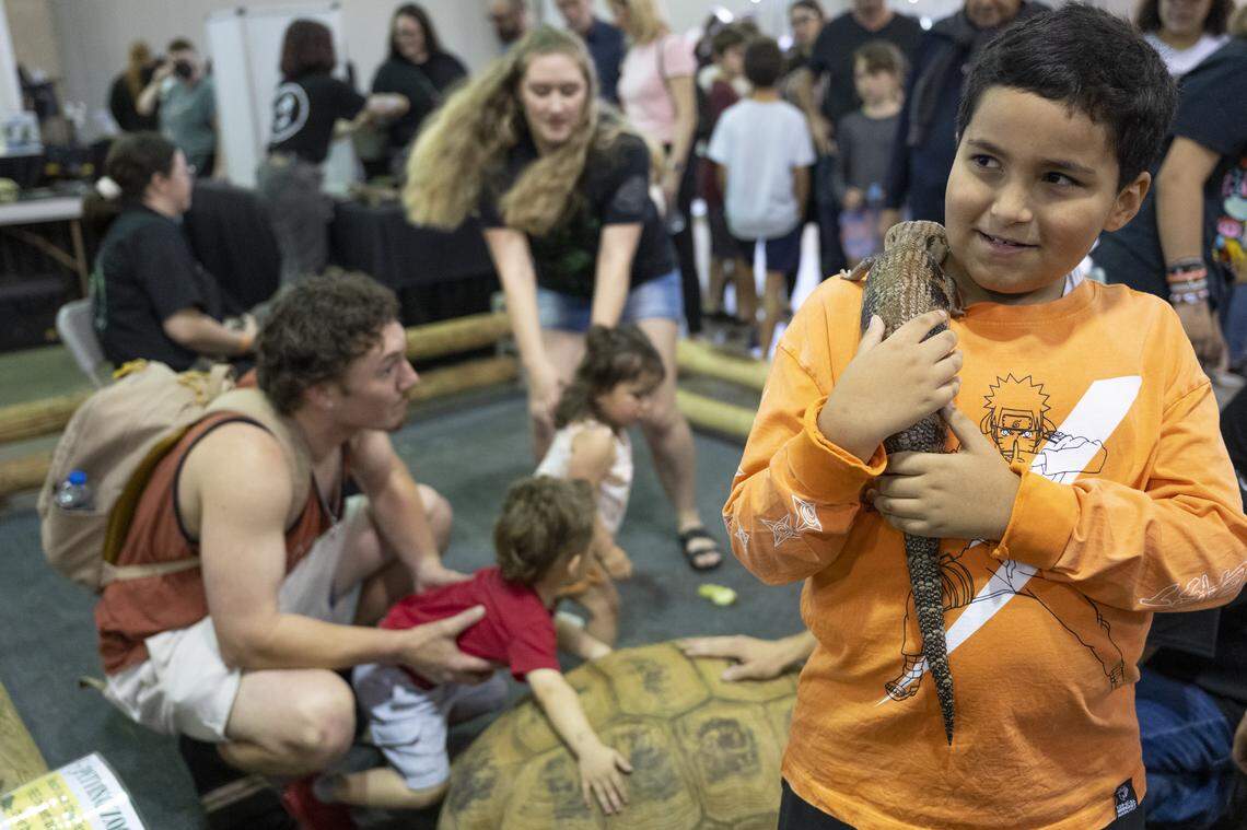 Jaxson Cervantez, 9, right, holds a blue tongued skink during the Sacramento Reptile Show at Cal Expo in Sacramento on Sunday, April 19, 2026.