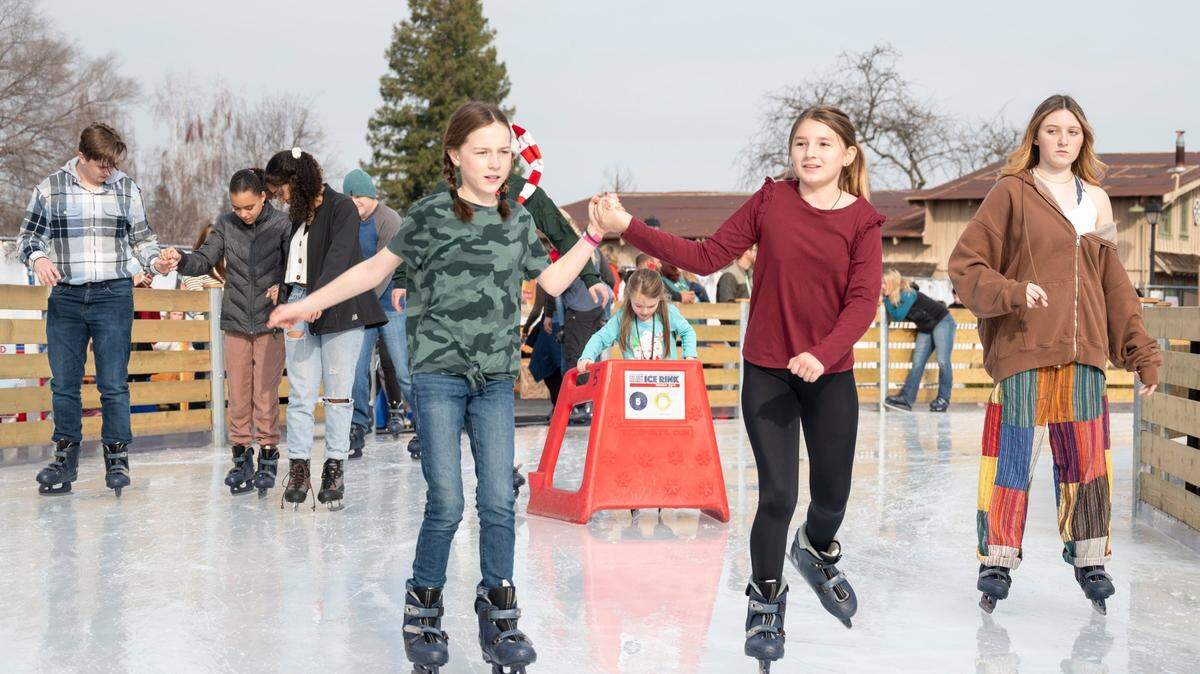 Cousins Cora Wong, left, 11, and Jules Ochoa, right, 11, hold hands while skating at Folsom Historic District Ice Rink in 2023. A new temporary ice rink opened this holiday season on Florin Road.