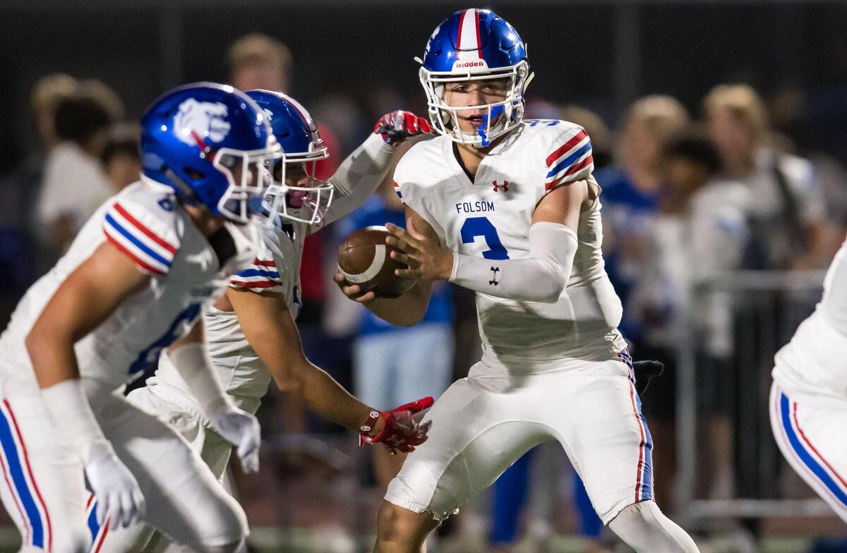 Folsom Bulldogs quarterback Ryder Lyons (3) fakes a handoff during a first quarter play against the Rocklin Thunder at the high school football game Friday at Rocklin High School.