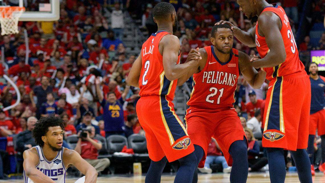 New Orleans Pelicans forward Darius Miller (21) is congratulated by guard Ian Clark (2) and forward Julius Randle (30) after he shot a three-pointer and was fouled by Sacramento Kings forward Marvin Bagley III (35) in the second half of an NBA basketball game in New Orleans, La., Friday, Oct. 19, 2018. The Pelicans won, 149-129. (AP Photo/Matthew Hinton)