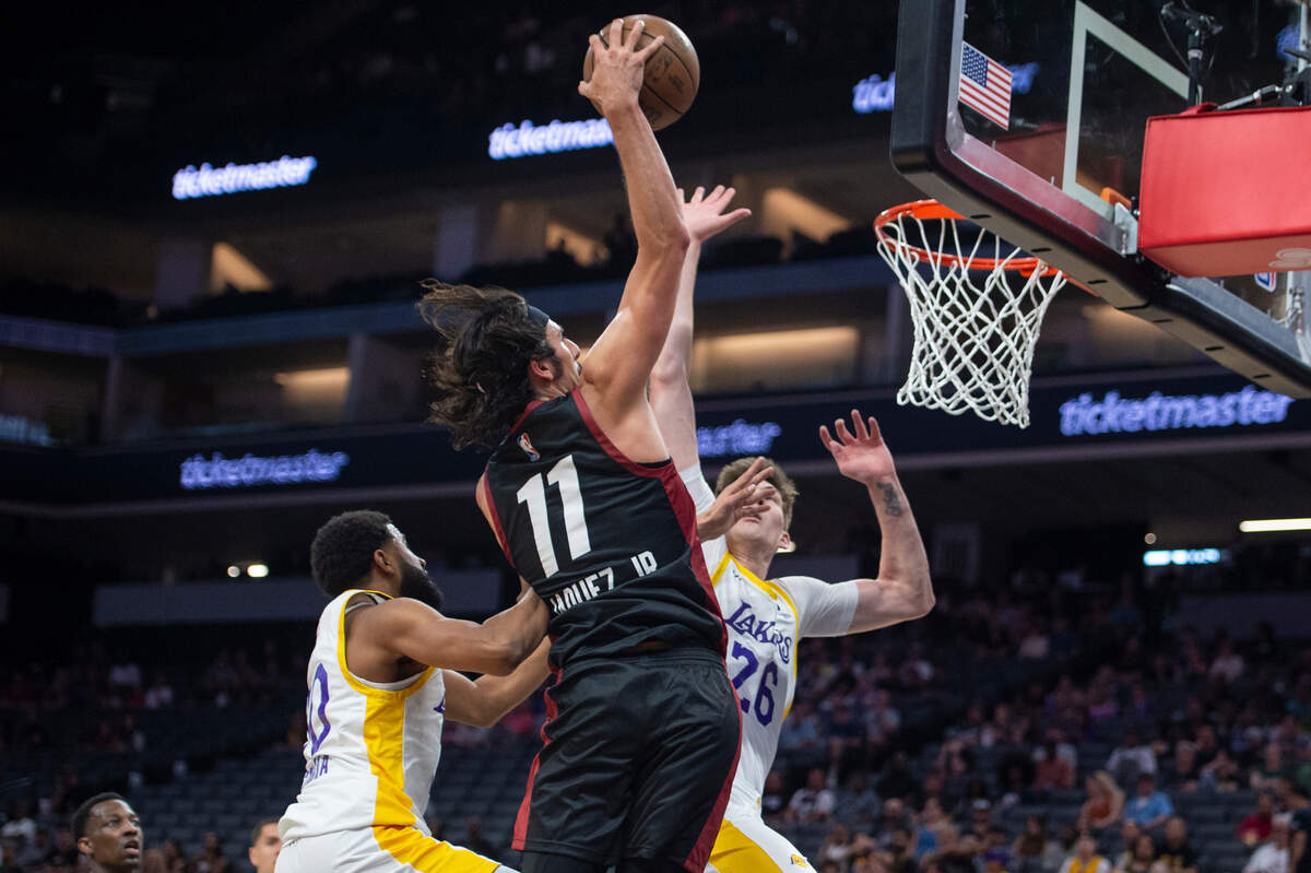 Miami Heat Jaime Jaquez Jr. (11) dunks the ball with Los Angeles Lakers Colin Castleton (26) defending in the first half of the California Classic Monday, July 3, 2023, at Golden 1 Center.