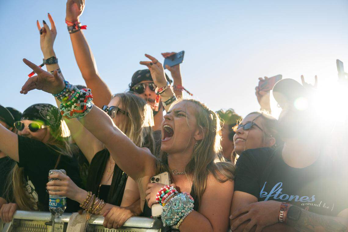 Makenzy Gilbert of Sacramento, decked out in beaded bracelets, enjoys a performance during the Aftershock festival on Friday, Oct. 3, 2025, in Discovery Park in Sacramento.  