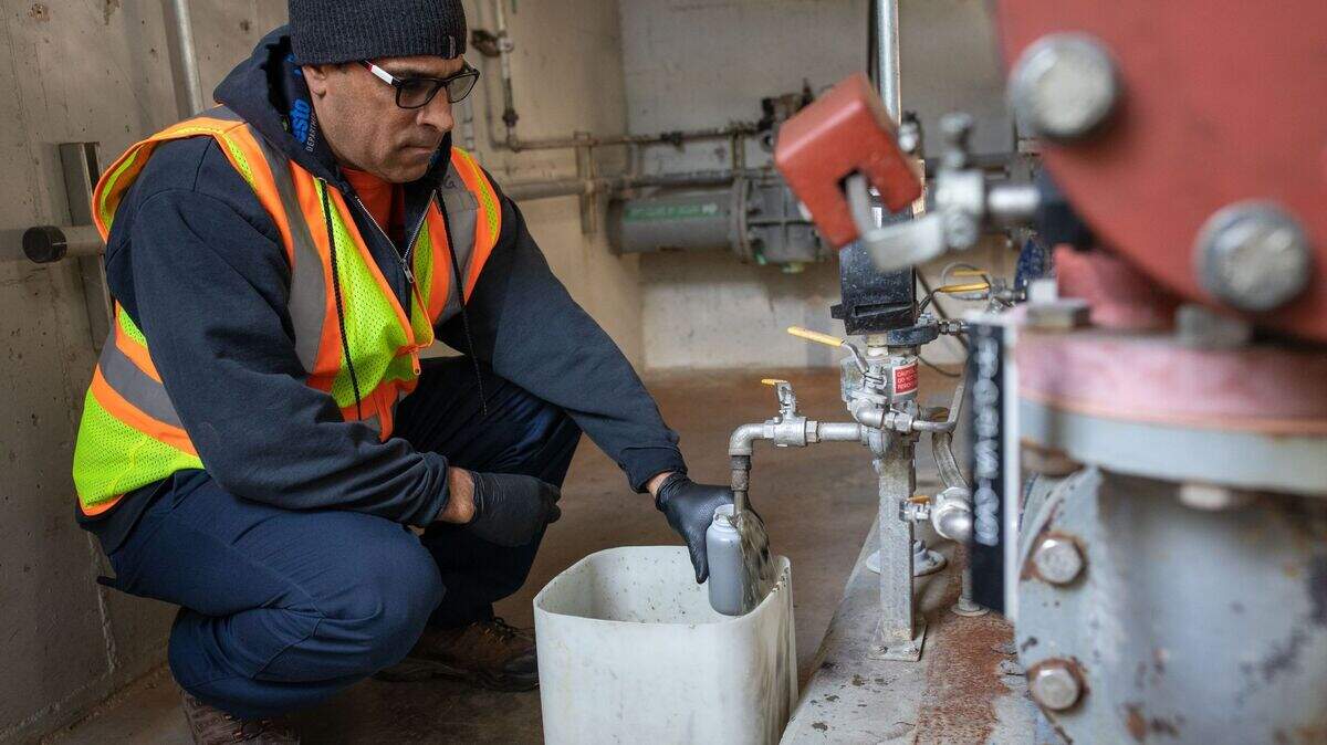 Patrick Green, a utilities plant operator in Modesto, siphons wastewater sludge to be analyzed for evidence of SARS-CoV-2, the virus that causes COVID-19. Across the country, sewage surveillance has become a crucial public health tool for community-level tracking of COVID-19 surges and variants. 